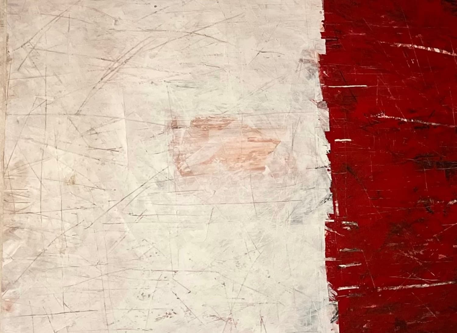 An abstract work: a scratched white field meeting a band of deep red along a torn vertical seam.